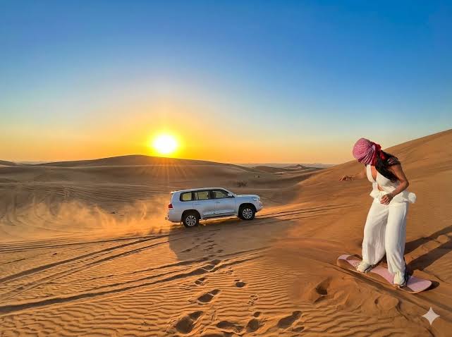 A 4x4 on the dunes in morning light