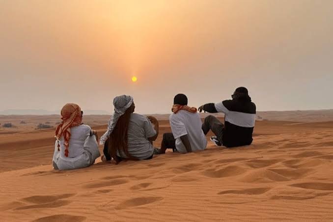 Sandboarding down a dune